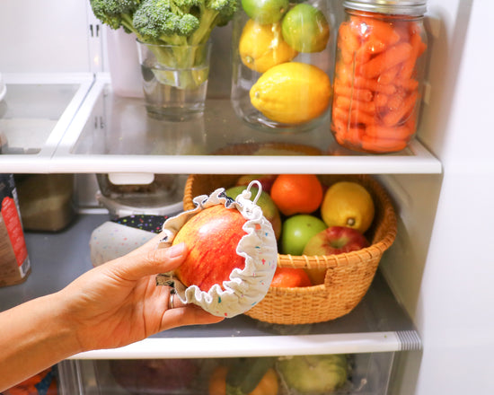 Storing a cut apple with food covers in fridge